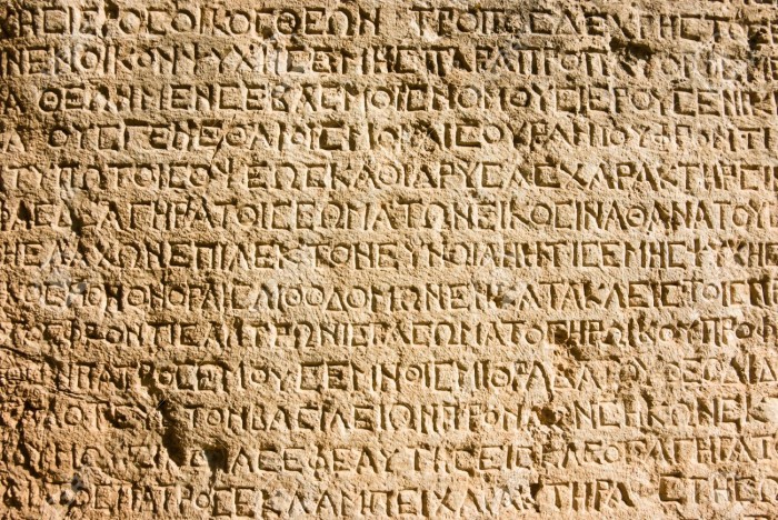 18217575-ancient-greek-writing-chiselled-on-stone-stock-photo